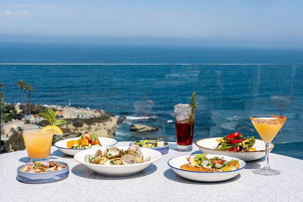 Food on table with ocean in the background