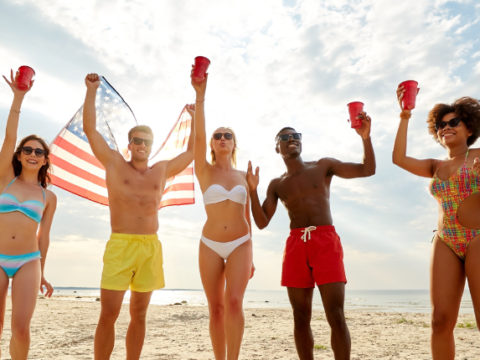 friends on beach with american flag
