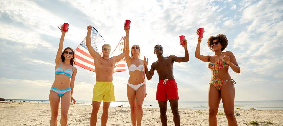 friends on beach with american flag