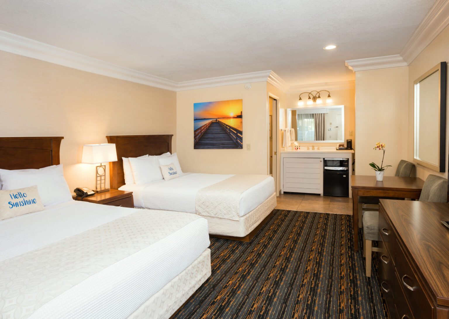 a clean guest room with two queen bed