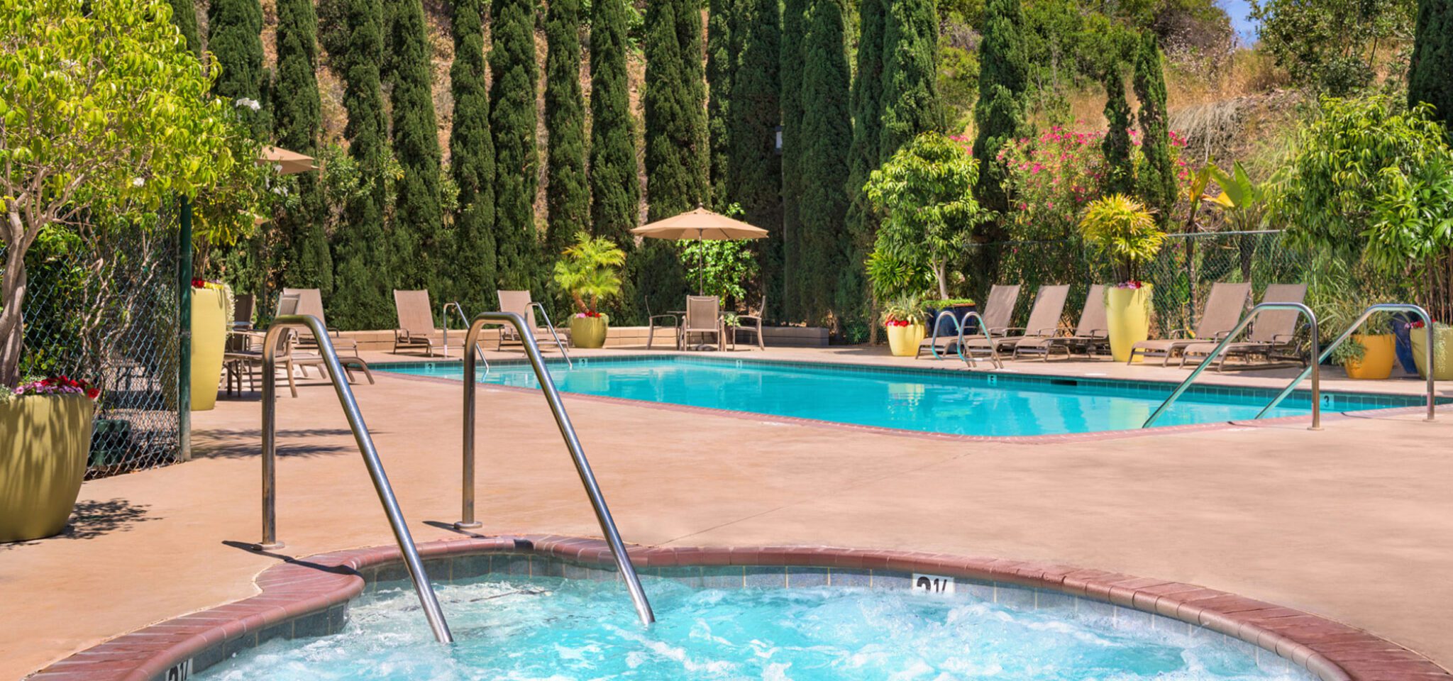 an outdoor swimming pool and hot tub