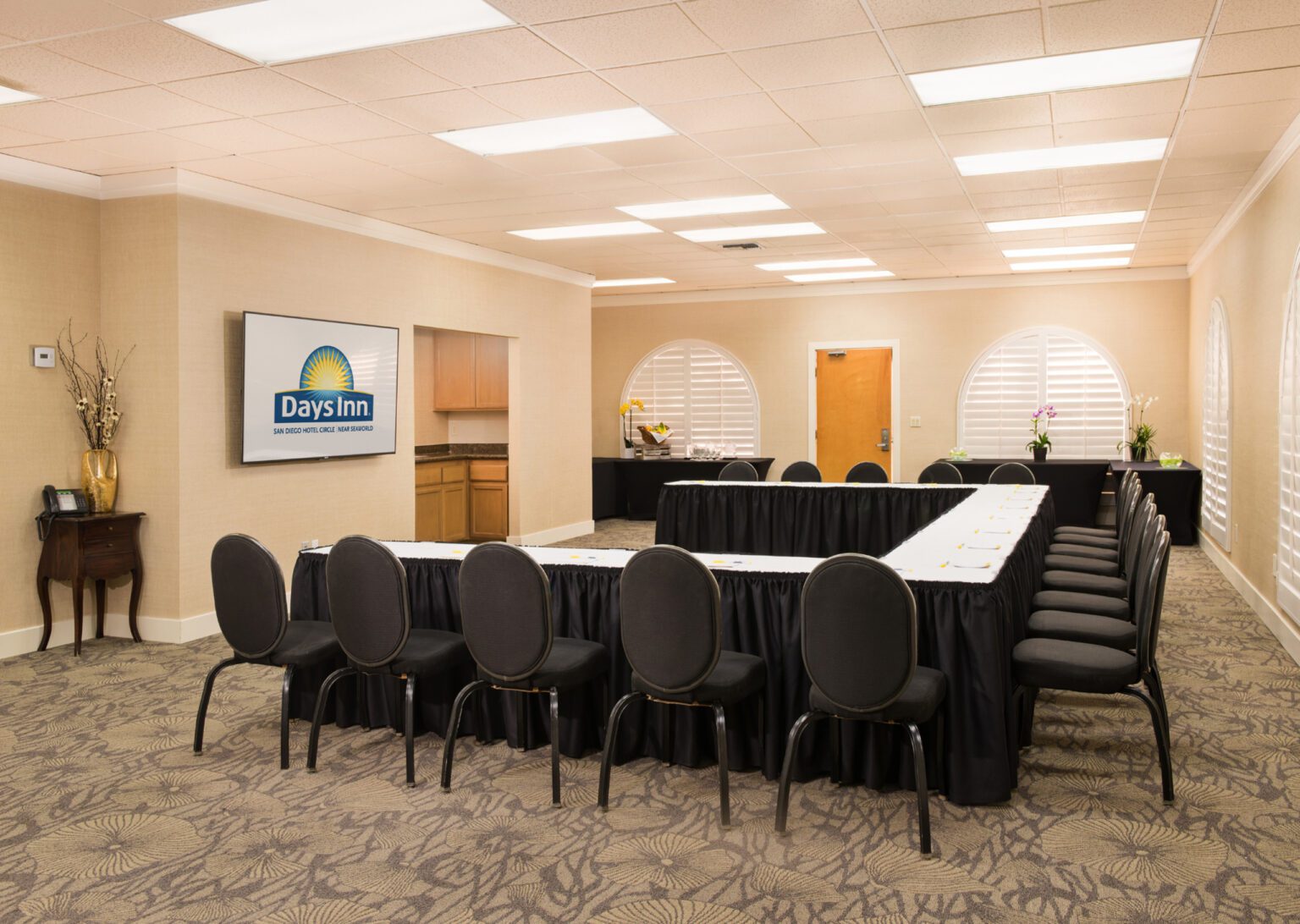 Meeting space with L shaped table and screen