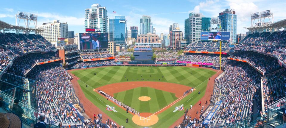 Wide-angle view of Petco Park filled with fans and downtown San Diego skyline.
