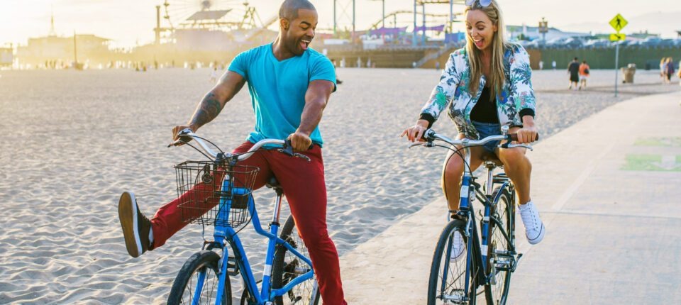 a man and woman goofing off on bicycles