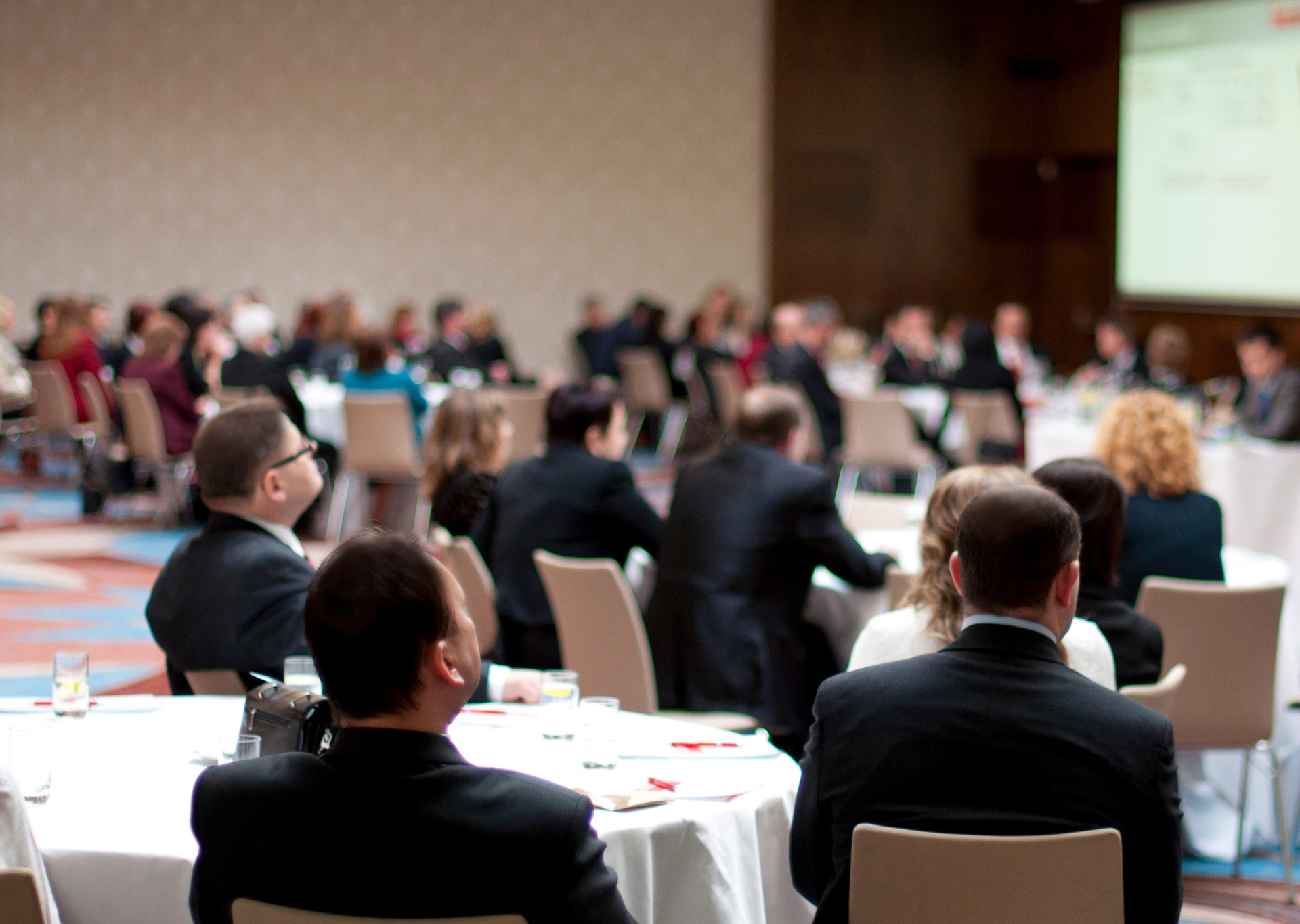 people attending a talk in a conference center