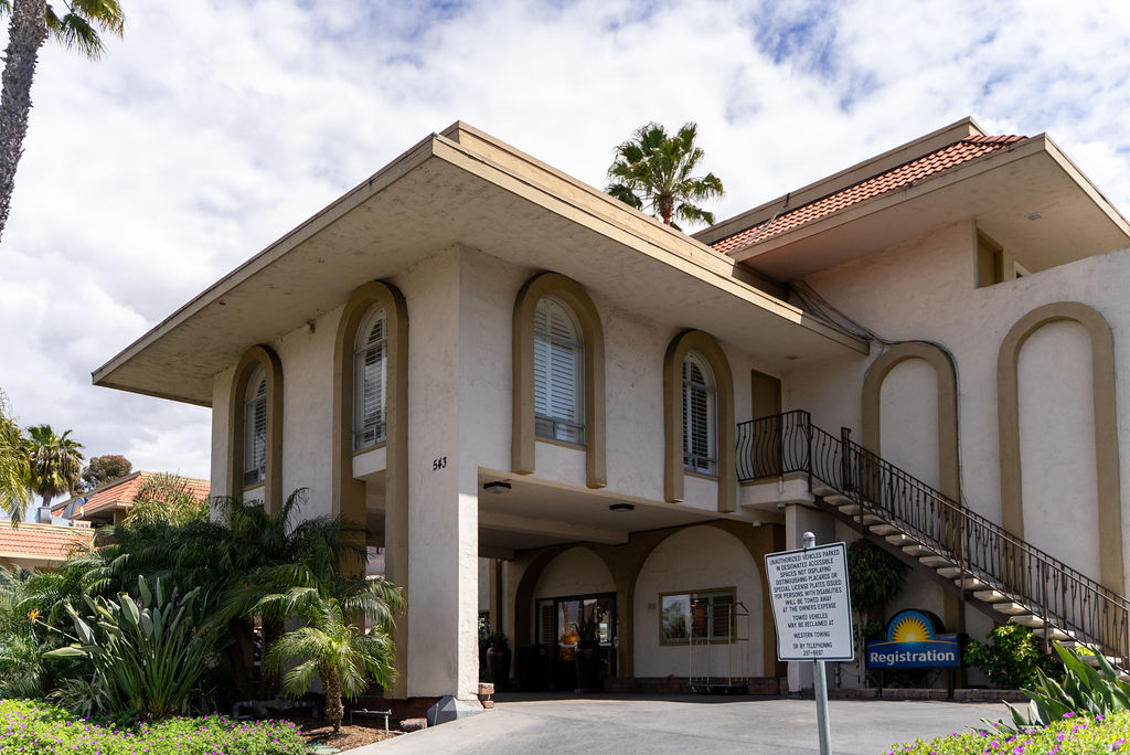 Hotel registration building with arched windows and stairway.