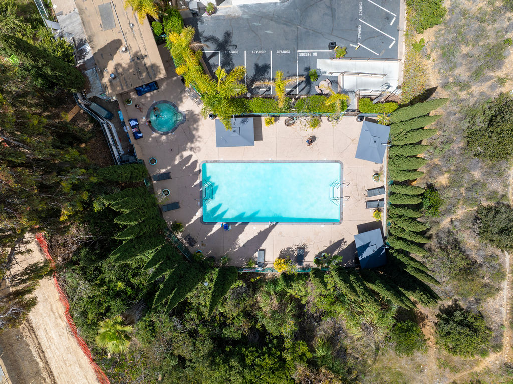 Aerial view of pool, hot tub, and lounge chairs.