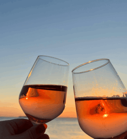 wine glasses overlooking water