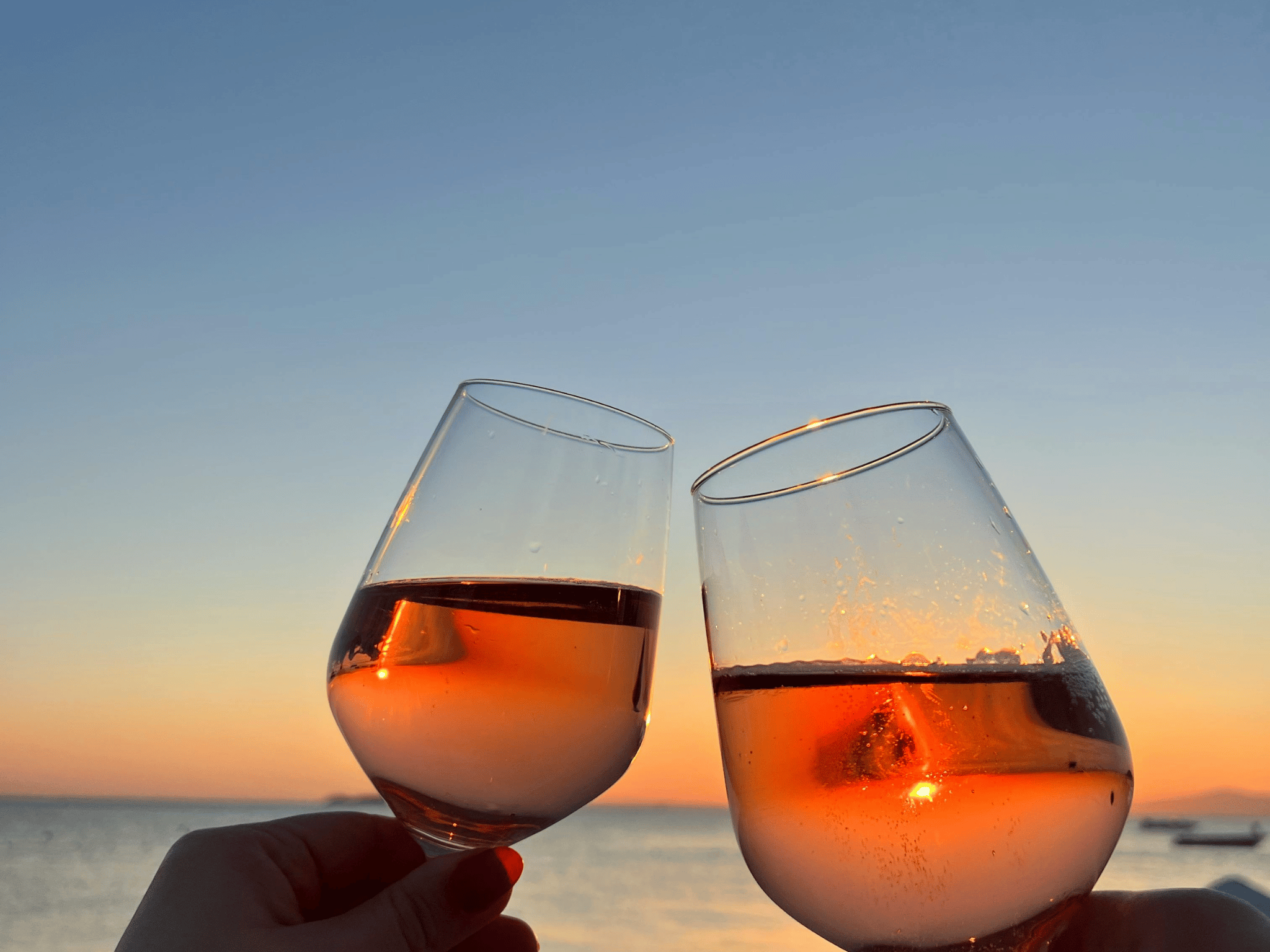 wine glasses overlooking water