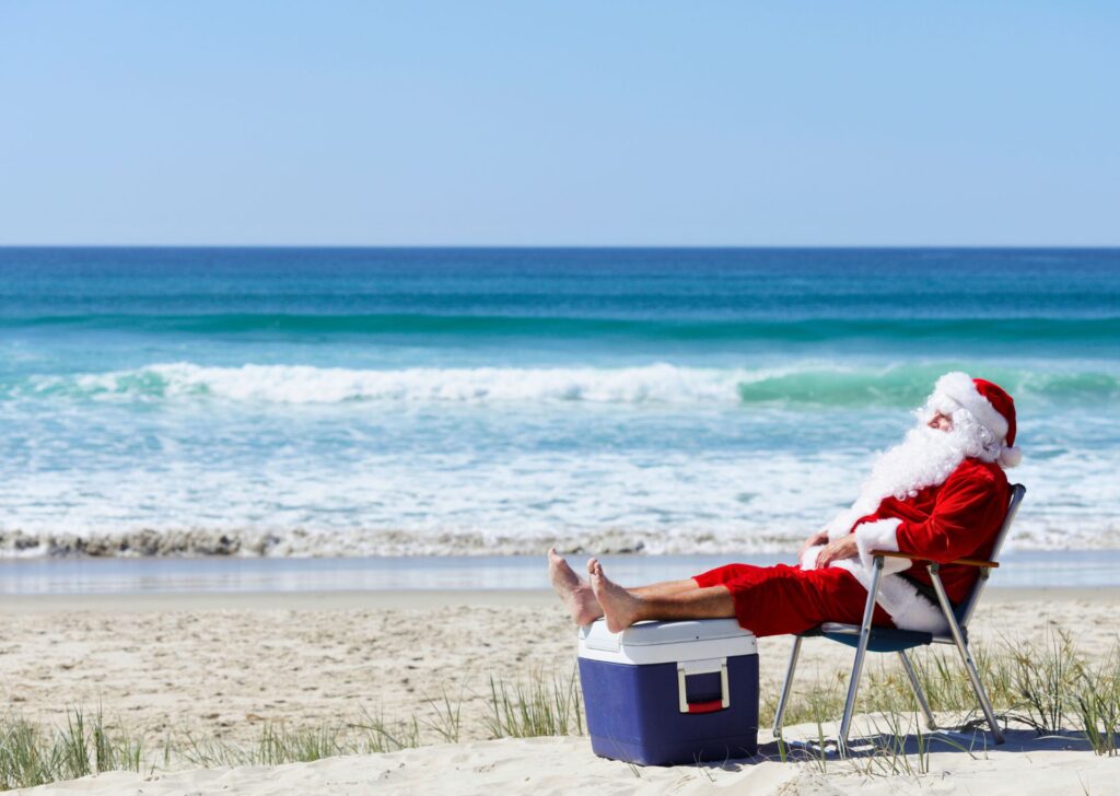 santa sitting on the beach