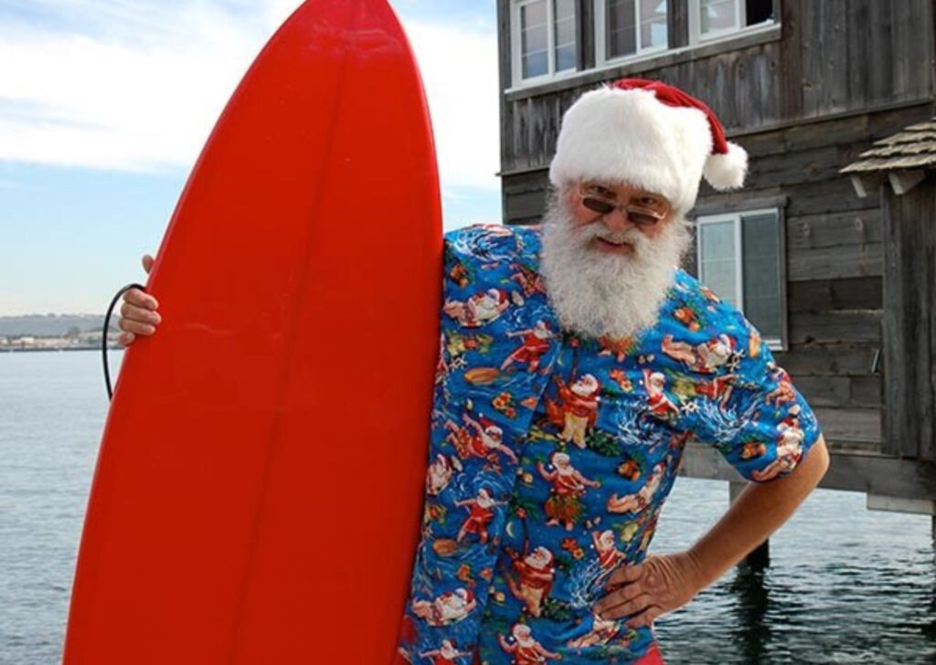 santa holding ssurf board