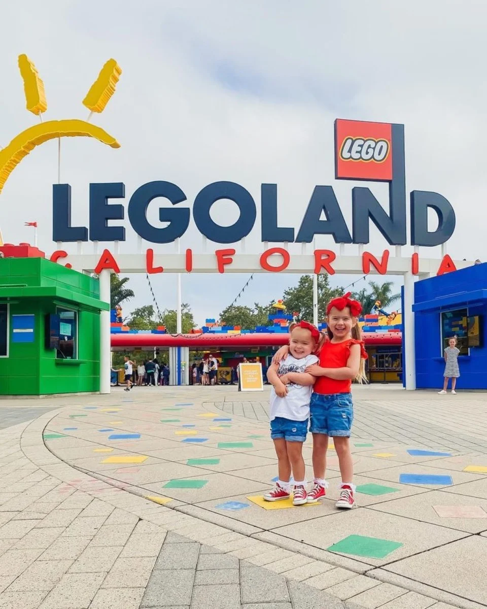 Two Girls in front of LEGOLAND sign