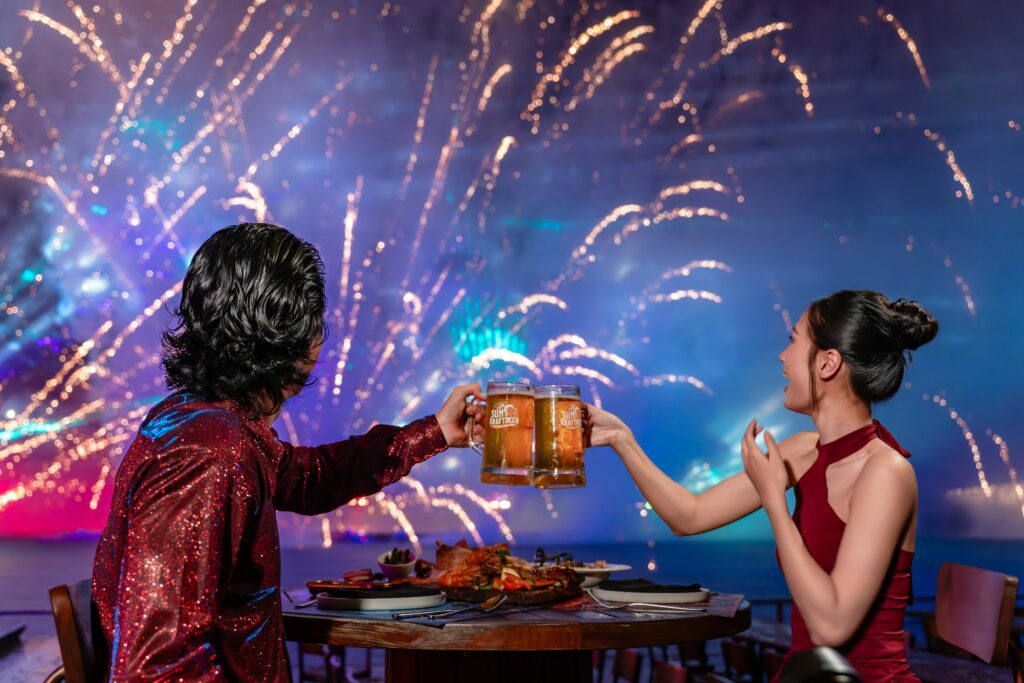 cheersing with beers with fireworks