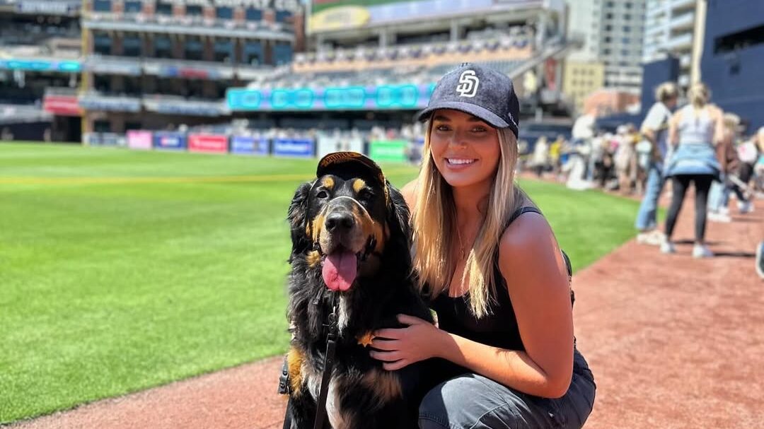 girl and dog at baseball game
